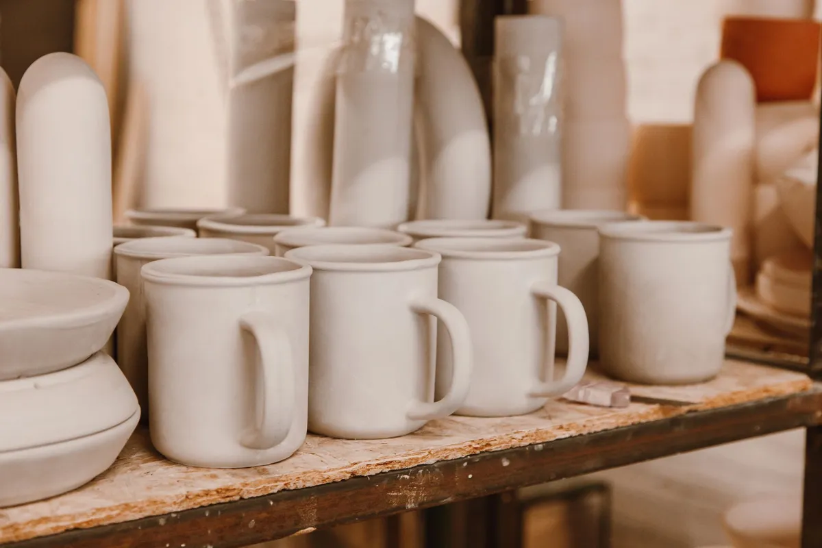 Handmade mug being glazed in a ceramics studio